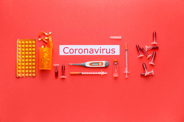 Test tubes with blood sample and medicines for Coronavirus on color background - Photo, image