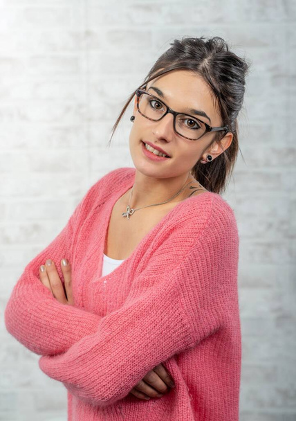 young smiling brunette woman with a pink sweater - Φωτογραφία, εικόνα