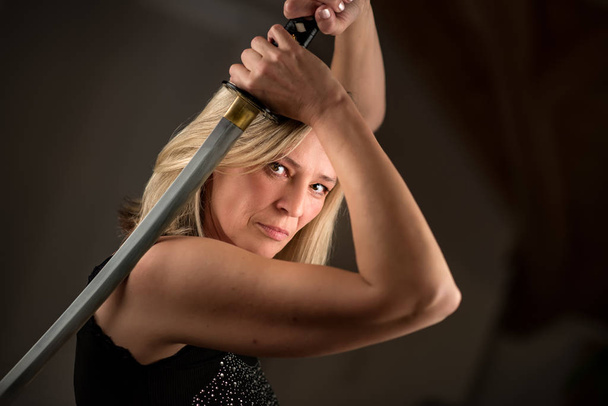 Strong female fighter with samurai sword in action - Zdjęcie, obraz