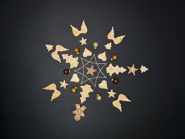 Christmas star shaped out of different Christmas deco items, on black chalkboard - Photo, Image