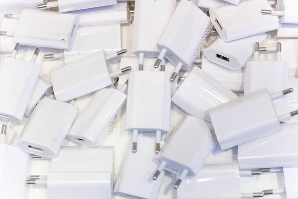 White usb charging heads close-up. There are a lot of them. - Photo, Image