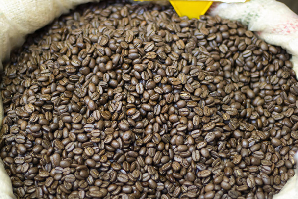 Photo of coffee beans in sack. Photographed in front of the market. Close up - Фото, изображение