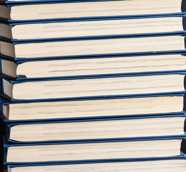 large stack of books in a blue cover, close up, full frame - Foto, Imagen