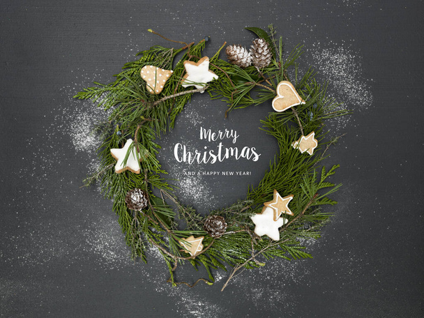 green christmas wreath on black background with many different christmas items and lettering merry christmas - Photo, Image