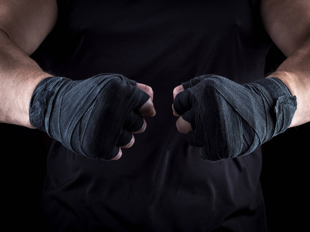two men's hands wrapped in a black bandage, close up - Foto, Imagem
