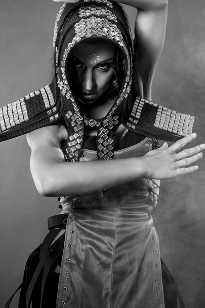 Strong dance, Beautiful brunette woman in armor formed by mirror - Foto, Bild