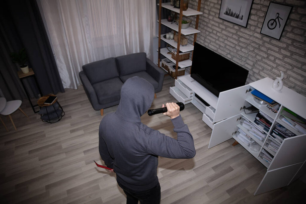 Thief With Flashlight Looking At Files In Shelf - Foto, Imagem