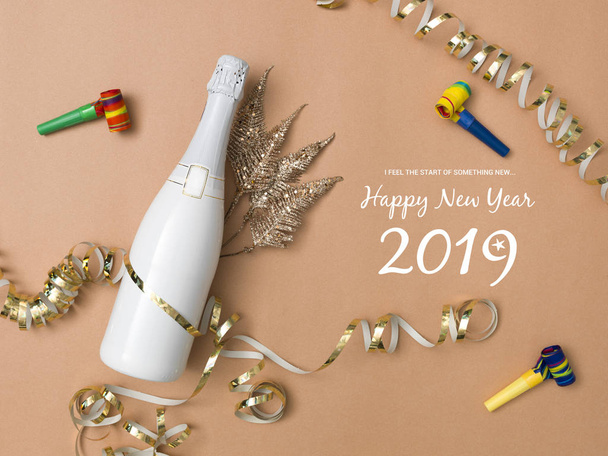 modern new year background with bottle of champagne on bronze, gold, brown background with different New Year's Eve items - Foto, imagen