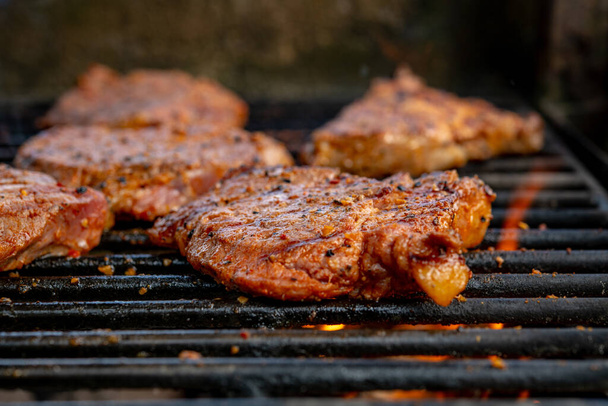 grilled pork with flames on charcoal barbecue - Photo, Image
