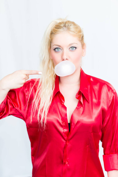 Blonde woman chews gum - 写真・画像