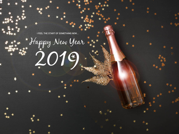 New Year's background with a bottle of champagne on black chalkboard - Foto, Bild