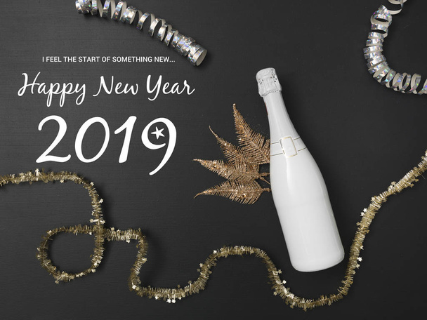 New Year's background with a bottle of champagne on black chalkboard - Foto, imagen