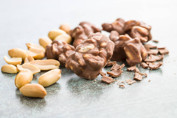 Peanuts covered chocolate. Tasty sweet chocolate truffles. - Фото, зображення