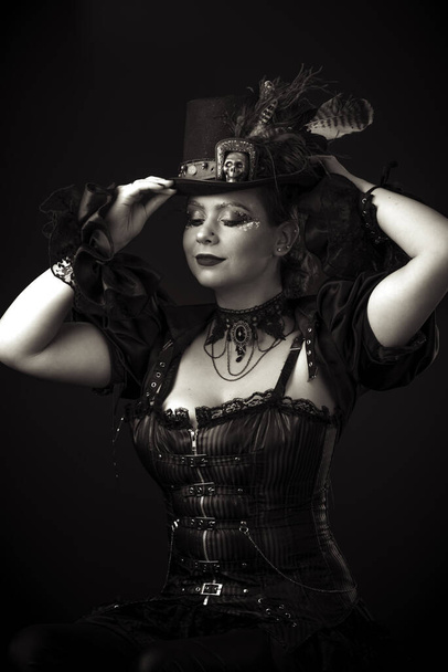 Emotional Portrait of Young Woman in Steampunk or Retro style. Studio shot. Model on a Black Background - Foto, immagini