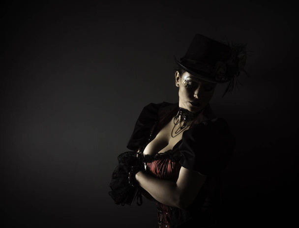 Emotional Portrait of Young Woman in Steampunk or Retro style. Studio shot. Model on a Black Background - Fotoğraf, Görsel