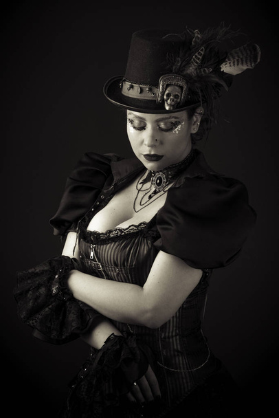 Emotional Portrait of Young Woman in Steampunk or Retro style. Studio shot. Model on a Black Background - Foto, imagen