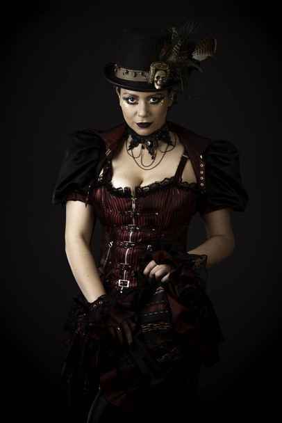 Emotional Portrait of Young Woman in Steampunk or Retro style. Studio shot. Model on a Black Background - 写真・画像