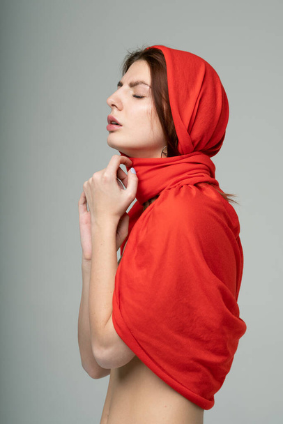 portrait of a young beautiful girl in a red scarf - Fotografie, Obrázek