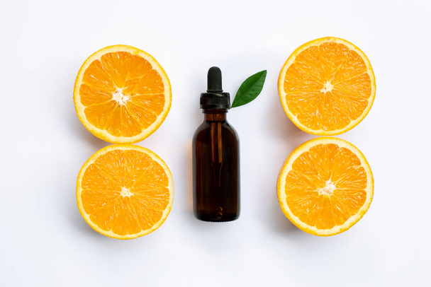 Essential oil with orange slices isolated on white - Photo, Image