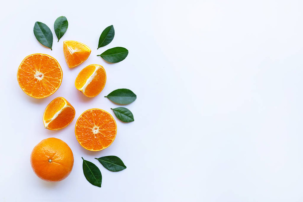 Oranges and green leaves on white background. Copy space - Foto, immagini