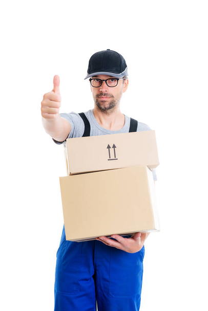 friendly postman with cap and parcels and thumb up - Foto, afbeelding