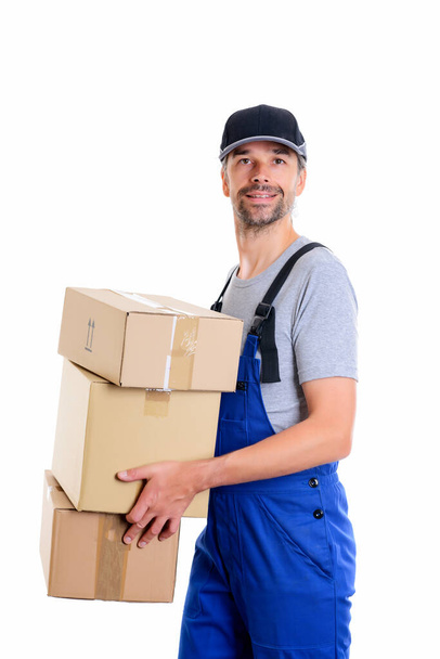friendly postman with parcels in front of white background - 写真・画像