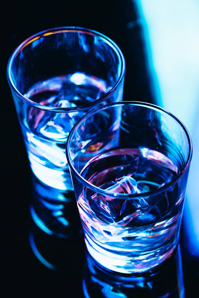 drinking glasses with ice close-up on a dark background. - Φωτογραφία, εικόνα