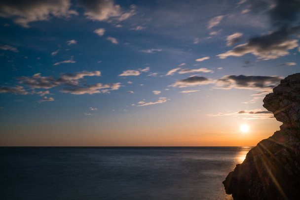 Beautiful sunset over the cliffs in Petrovac coast, Montenegro - Foto, imagen