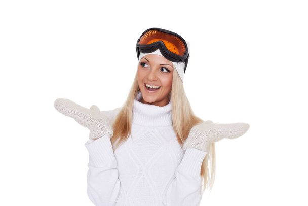 Portrait of surprised young  woman  in winter warm clothes and ski glasses on a white background. Winter sports. - Фото, зображення