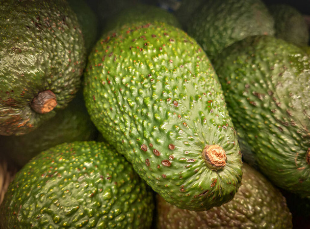 Fresh green avocados or Persea Americana ready for sale. Tropical avocados fruits on market stall. - Photo, Image