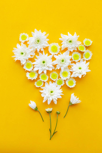 Composition of flowers on yellow paper background. - Photo, Image