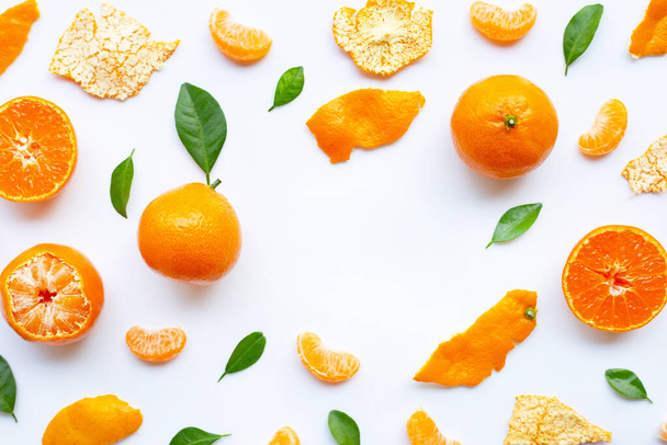 Orange fruits and green leaves on a white background. Copy space - Fotoğraf, Görsel