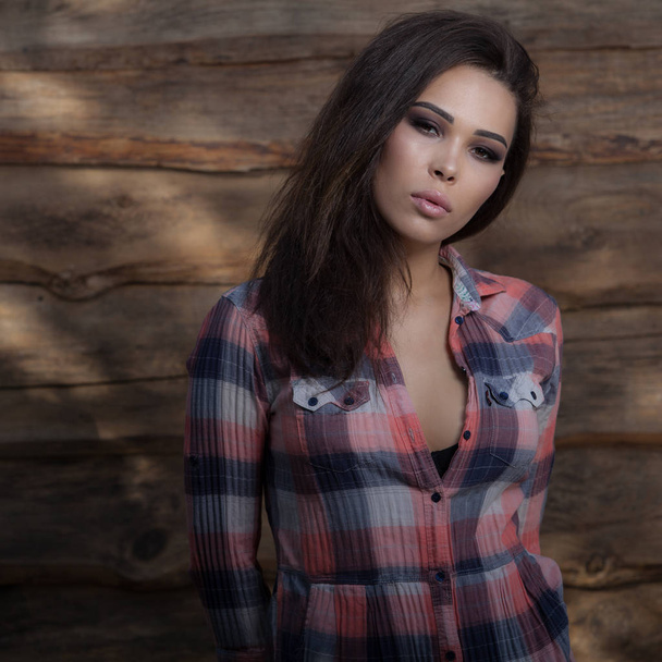 Portrait of beautiful young girl on wooden background. - Zdjęcie, obraz
