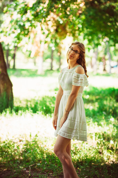 Beautiful young girl on natural background. - Zdjęcie, obraz