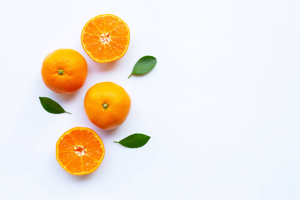Orange citrus fruit with green leaves on white background. - Photo, image