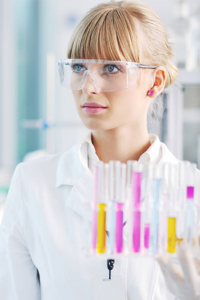doctor student  female researcher holding up a test tube in chemistry bright labaratory - Foto, immagini