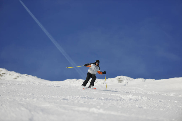 skier free ride downhill at winter season on beautiful sunny day  - Fotoğraf, Görsel
