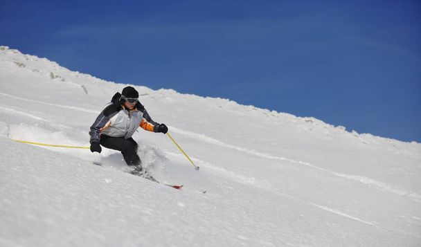 skier free ride downhill at winter season on beautiful sunny day  - Fotó, kép