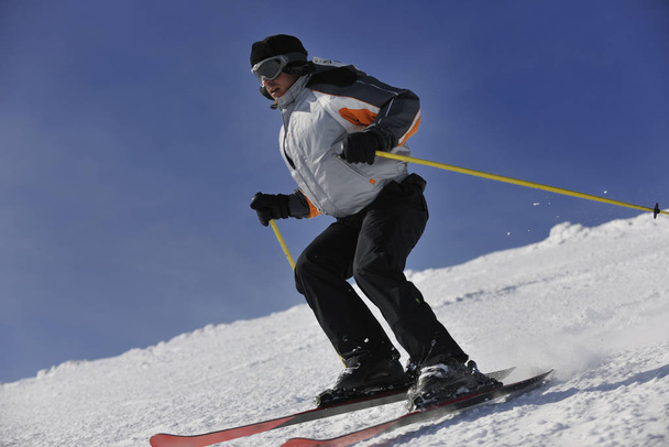 man ski free ride downhill at winter season on beautiful sunny day and powder snow - Foto, Imagen