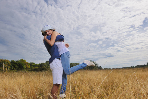 happy young couple have romantic time outdoor while smiling and hug - Photo, image