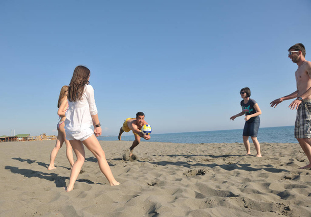 young people group have fun and play beach volleyball at sunny summer day - Φωτογραφία, εικόνα