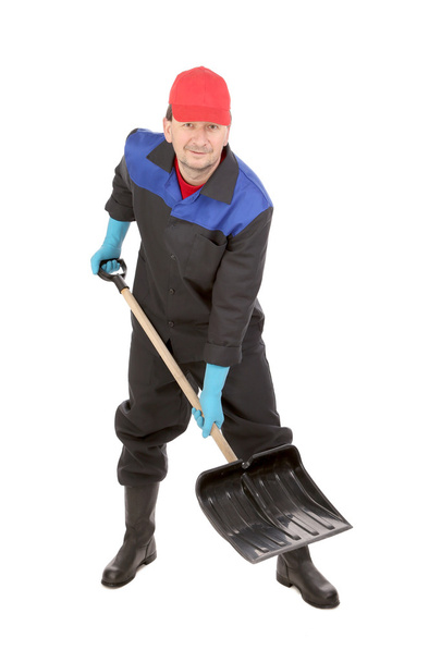 Worker holding black shovel. - Zdjęcie, obraz