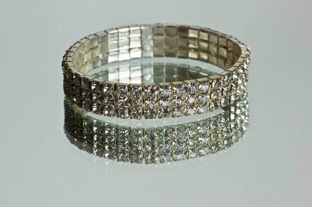 Diamond bracelet with many stones on reflective background - Valokuva, kuva