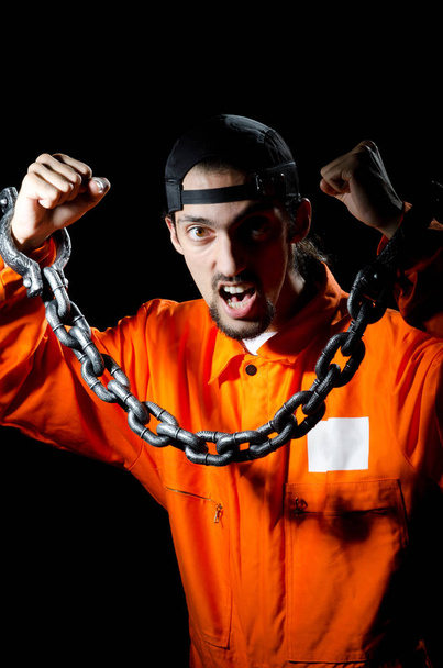 Inmate chained on black background - Фото, зображення