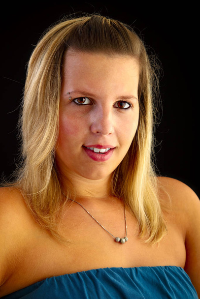 Young blond woman on black background, studio shot. Adobe RGB - Fotoğraf, Görsel