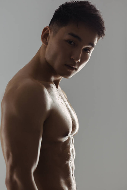 Portrait of Muscular Asian Man Indoors in Studio - Fotó, kép