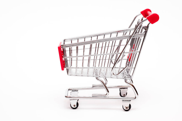 shopping cart from the side against white background - Foto, immagini