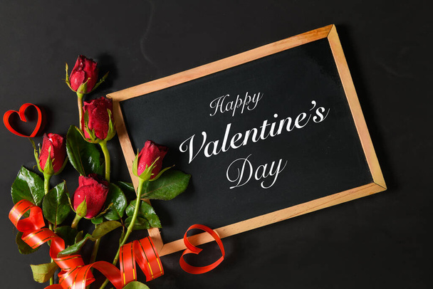 Valentine's day text on blackboard with red roses  - Photo, Image