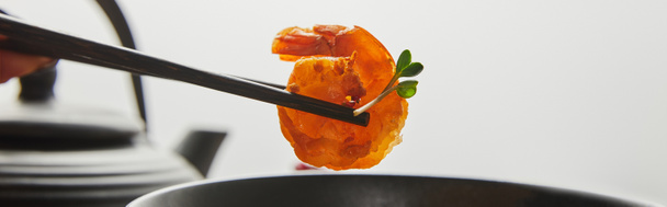 cropped view of woman holding shrimp with chopsticks near bowl isolated on grey, panoramic shot - Photo, Image