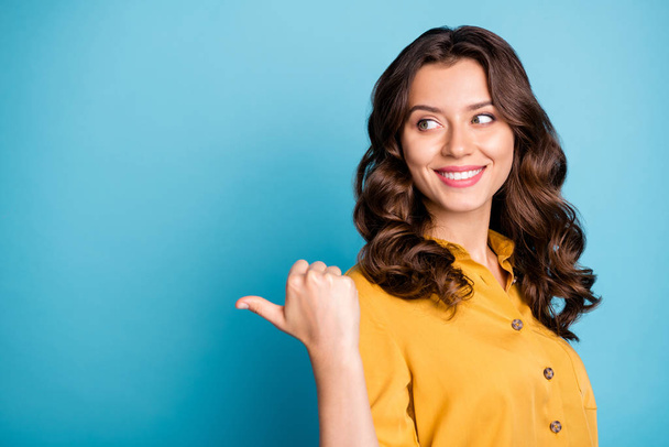 Close-up portrait of her she nice attractive charming confident cheerful cheery wavy-haired girl showing thumb aside ad isolated over bright vivid shine vibrant green blue turquoise color background - Foto, imagen